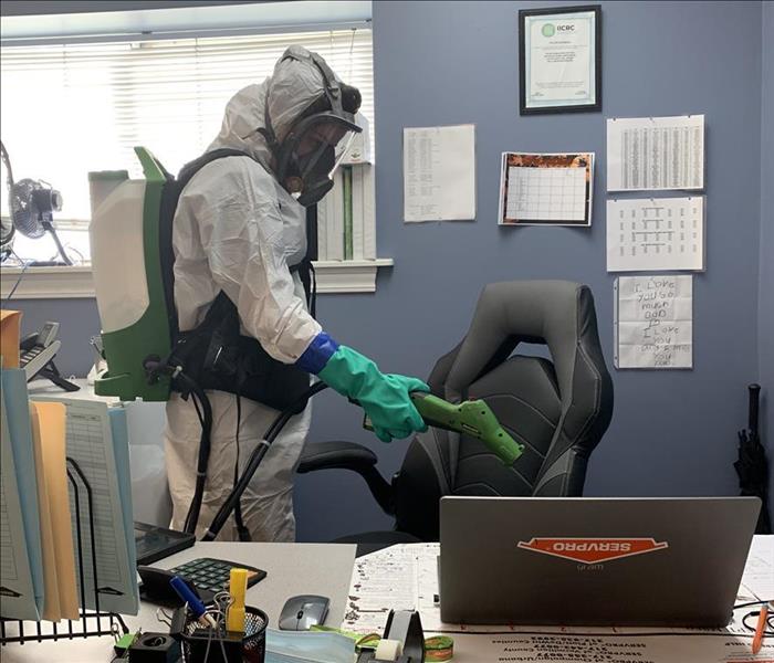 Technician disinfecting an office